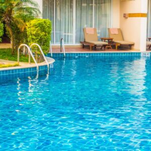 Empty Umbrella and chair around swimming pool in hotel resort