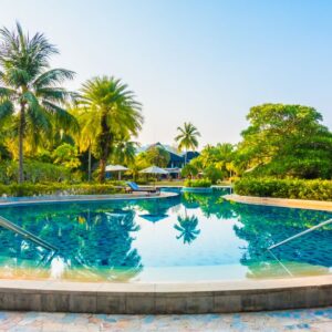 Umbrella and chair around beautiful luxury outdoor swimming pool in hotel resort - Boost up color Processing